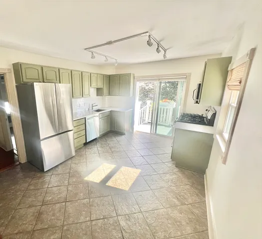 a kitchen with stainless steel appliances granite countertop a refrigerator and a sink
