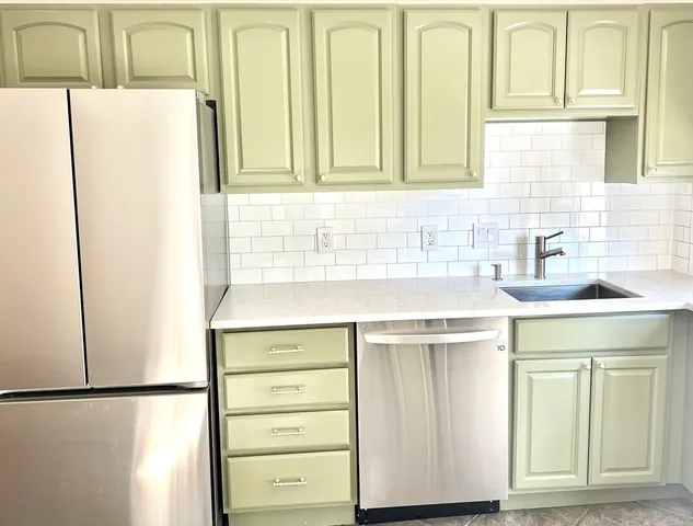 a kitchen with a sink and a refrigerator