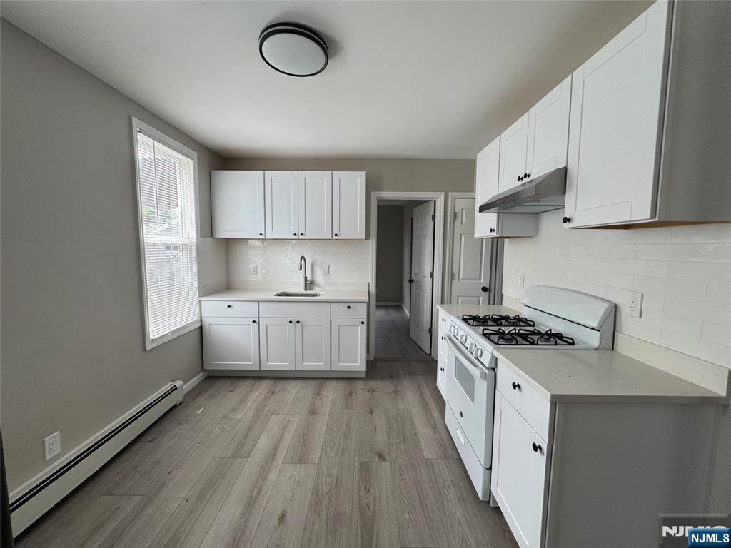 138 Carlton Avenue East Rutherford, NJ 07073 - Photo 3 of 14 a kitchen with cabinets a sink and a stove