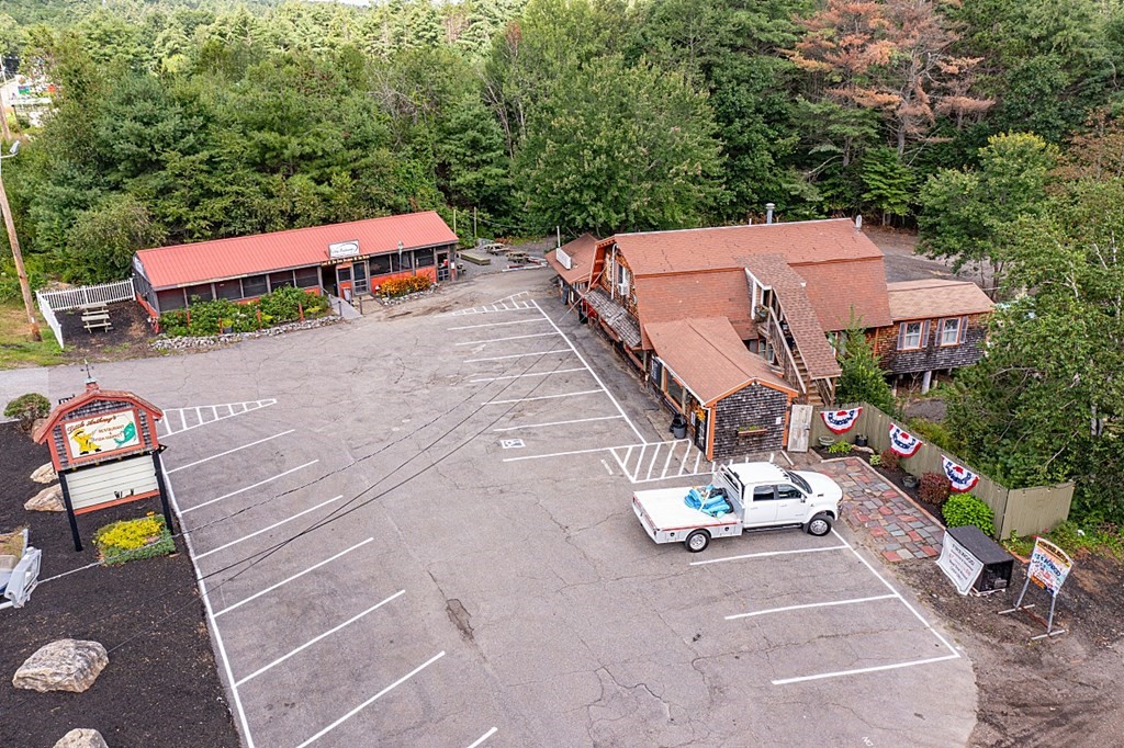 678 Spring Street Winchendon, MA 01475 - Photo 2 of 4 an aerial view of a tennis ground with large trees