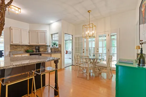 a kitchen with a refrigerator and a stove top oven