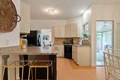 a utility room with dryer washer and wooden cabinets