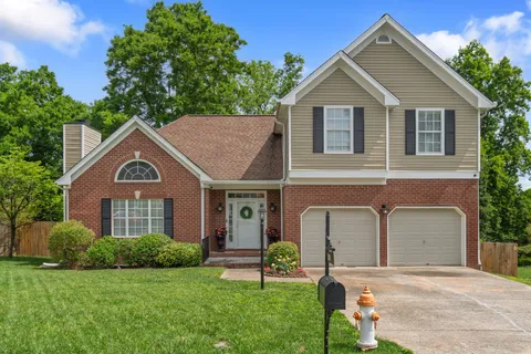 a front view of a house with a yard and garage