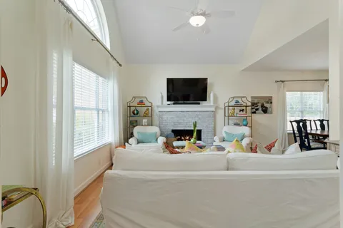 a living room with furniture a fireplace and a flat screen tv