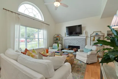 a living room with furniture a flat screen tv and a fireplace