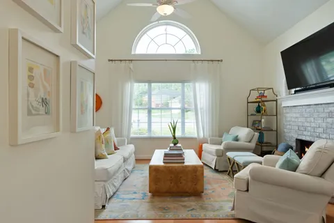 a living room with furniture fireplace and flat screen tv