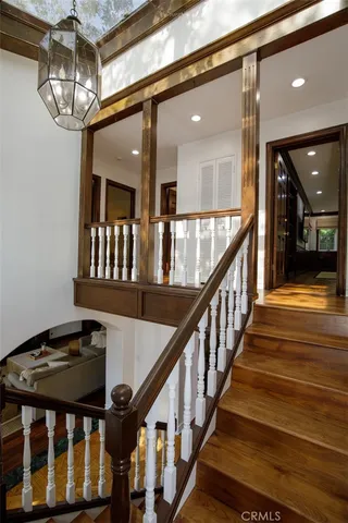 a view of entryway and hall with wooden floor