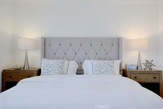 a bedroom with a bed and a night stand