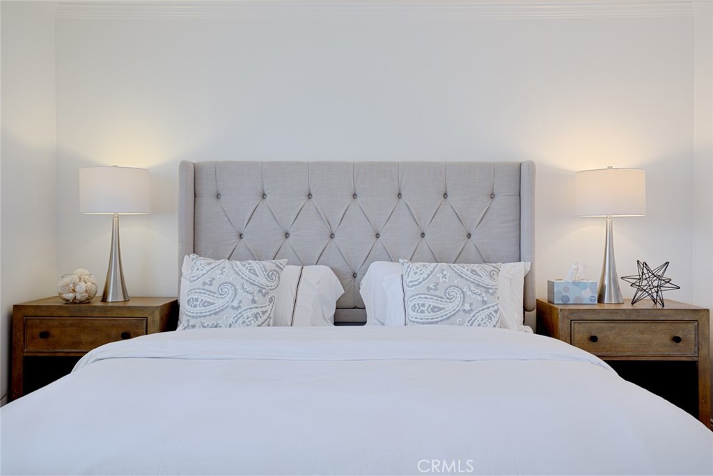 16842 Harkness Circle Huntington Beach, CA 92649 - Photo 13 of 43 a bedroom with a bed and a night stand