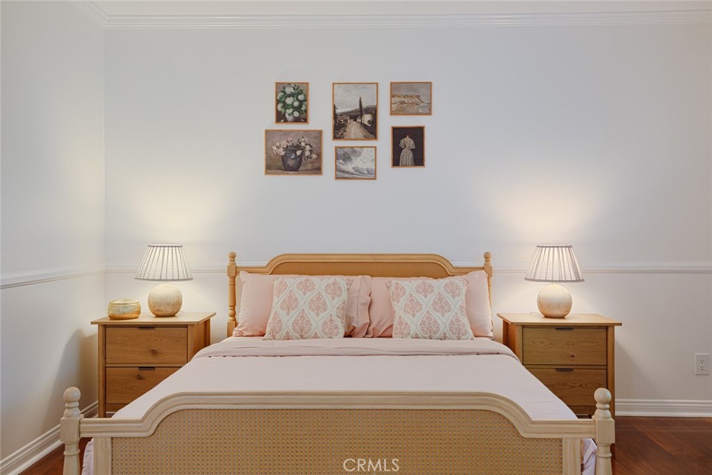 16842 Harkness Circle Huntington Beach, CA 92649 - Photo 14 of 43 a bedroom with a bed and painting on the wall