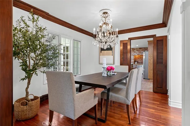 a view of a dining room with furniture and chandelier
