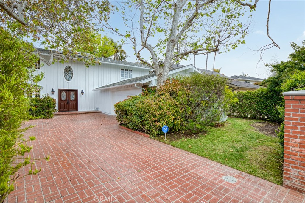 16842 Harkness Circle Huntington Beach, CA 92649 - Photo 2 of 43 a front view of a house with garden
