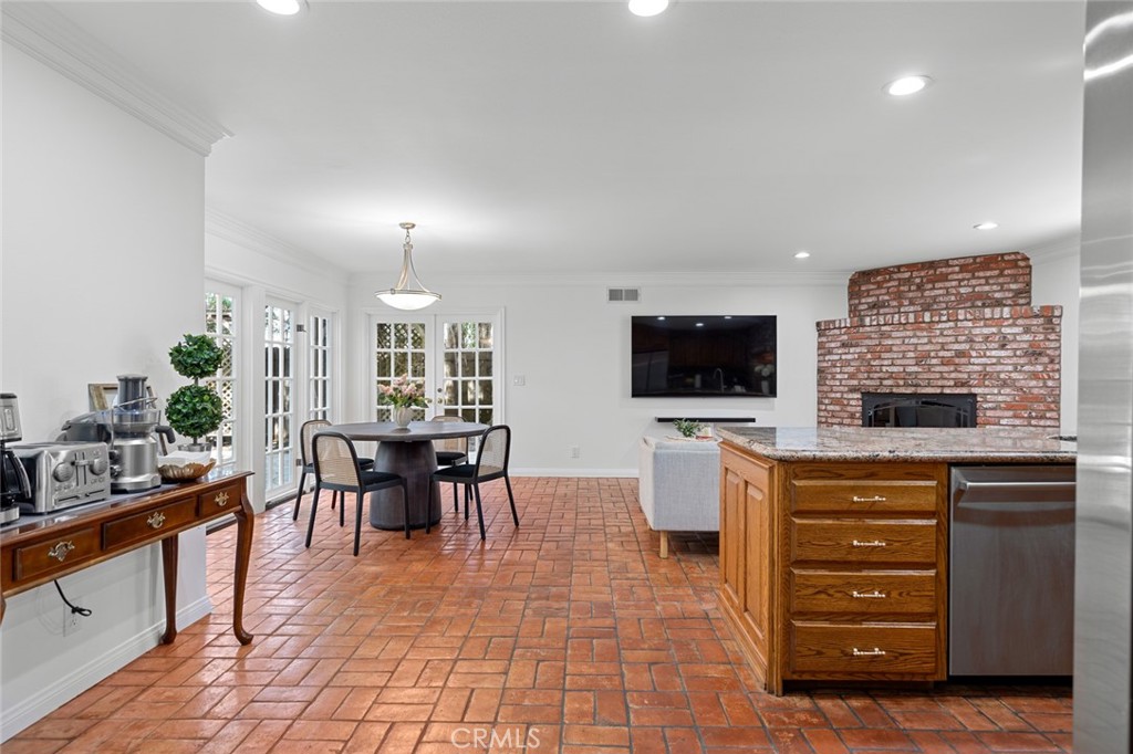 16842 Harkness Circle Huntington Beach, CA 92649 - Photo 21 of 43 a living room with furniture a flat screen tv and kitchen view