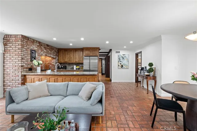 a living room with furniture and kitchen view