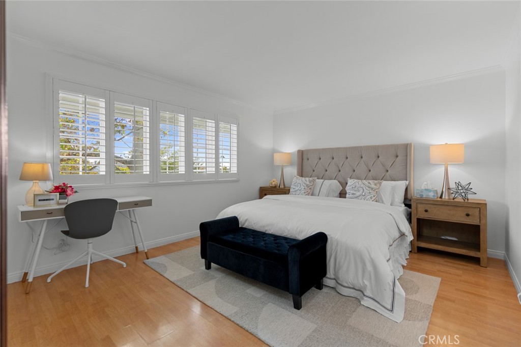 16842 Harkness Circle Huntington Beach, CA 92649 - Photo 30 of 43 a bedroom with a bed and a table chair