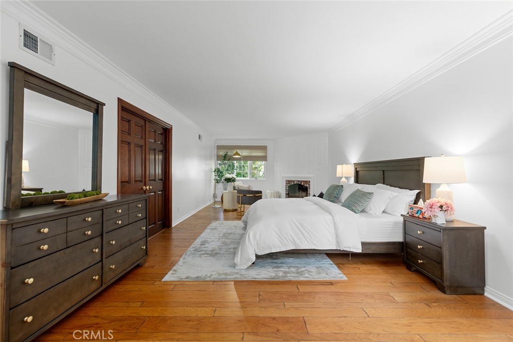 16842 Harkness Circle Huntington Beach, CA 92649 - Photo 38 of 43 a spacious bedroom with a bed and a dresser in it