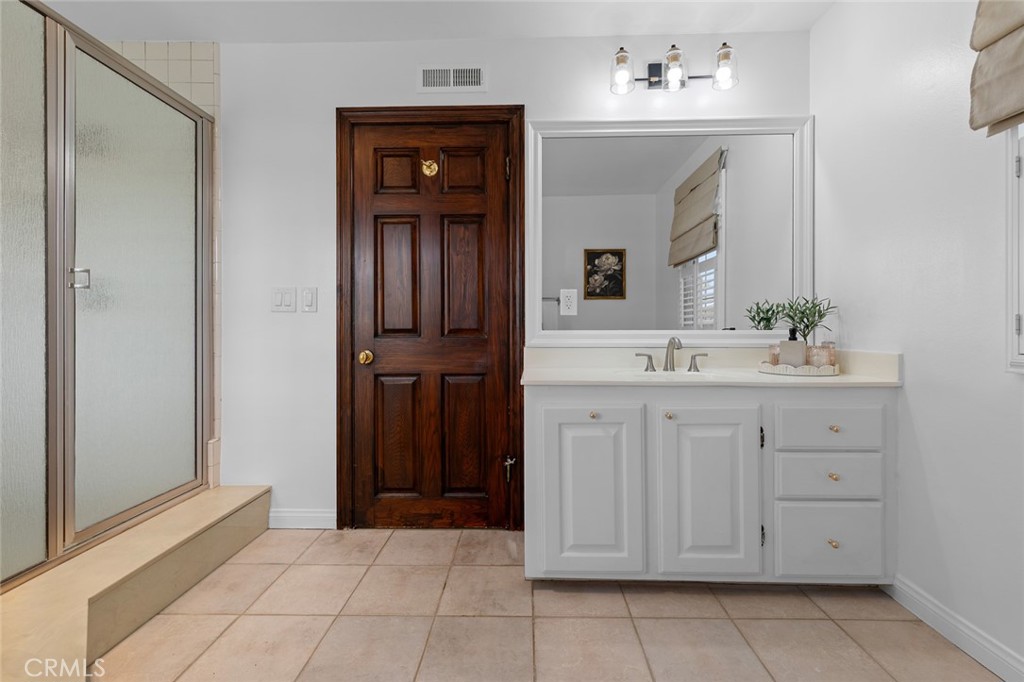 16842 Harkness Circle Huntington Beach, CA 92649 - Photo 42 of 43 a bathroom with a sink and a mirror