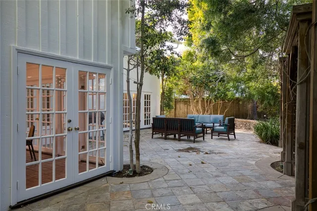 a view of backyard with a table and chairs and a large tree