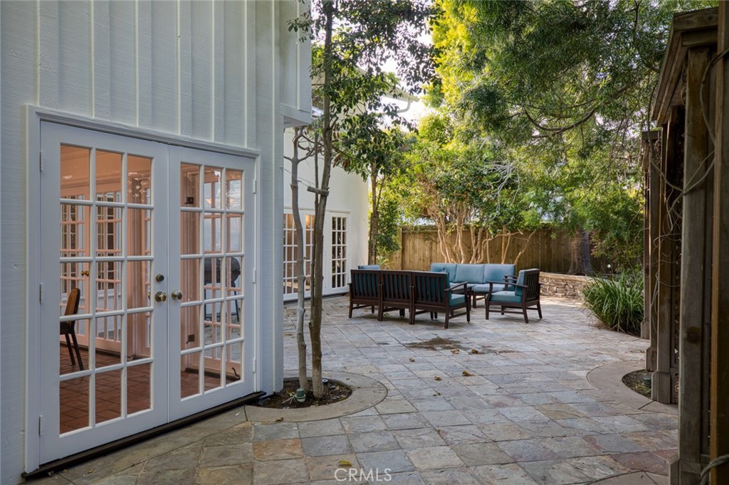 16842 Harkness Circle Huntington Beach, CA 92649 - Photo 5 of 43 a view of backyard with a table and chairs and a large tree