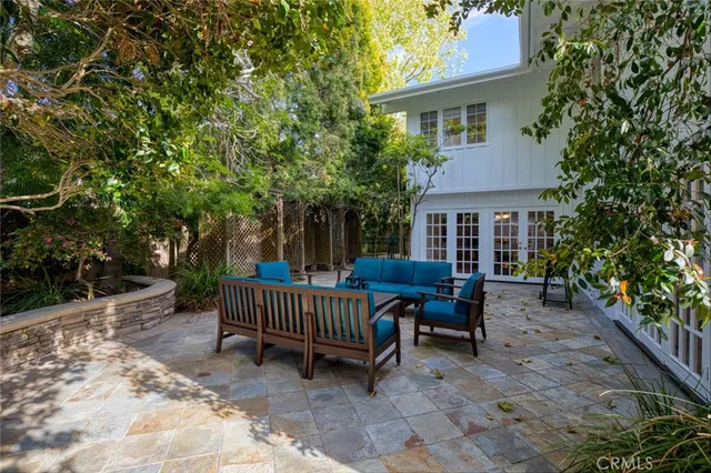 a view of backyard with deck and outdoor seating