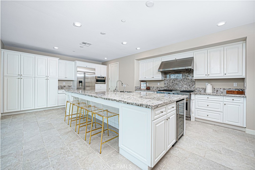 106 Tinker Irvine, CA 92618 - Photo 15 of 36 a kitchen with stainless steel appliances granite countertop a stove a sink and a refrigerator