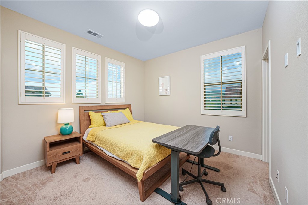106 Tinker Irvine, CA 92618 - Photo 28 of 36 a bedroom with a bed and a table