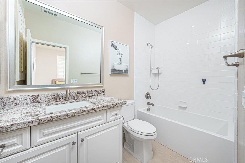 106 Tinker Irvine, CA 92618 - Photo 29 of 36 a bathroom with a granite countertop sink a toilet and a bathtub