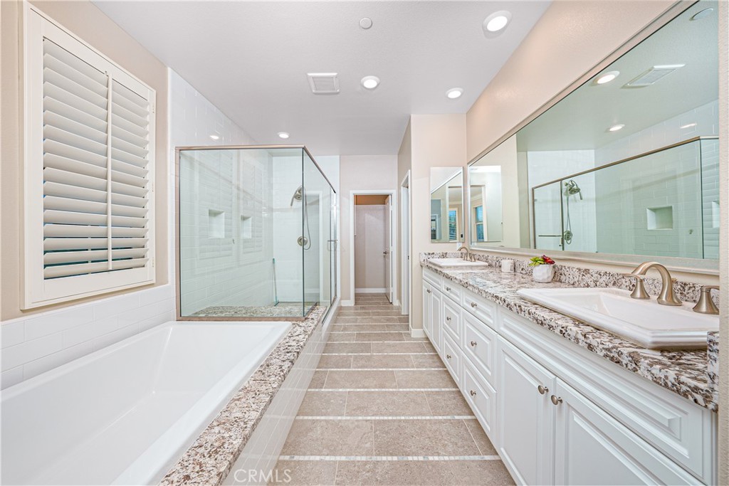 106 Tinker Irvine, CA 92618 - Photo 35 of 36 a spacious bathroom with a double vanity sink and a large mirror