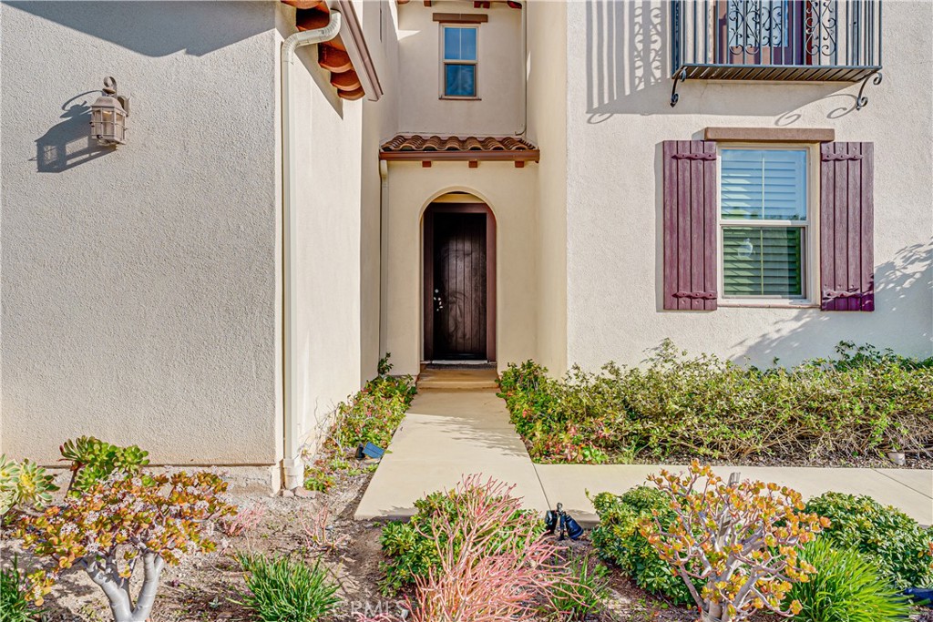 106 Tinker Irvine, CA 92618 - Photo 6 of 36 a front view of a house with a yard and flowers