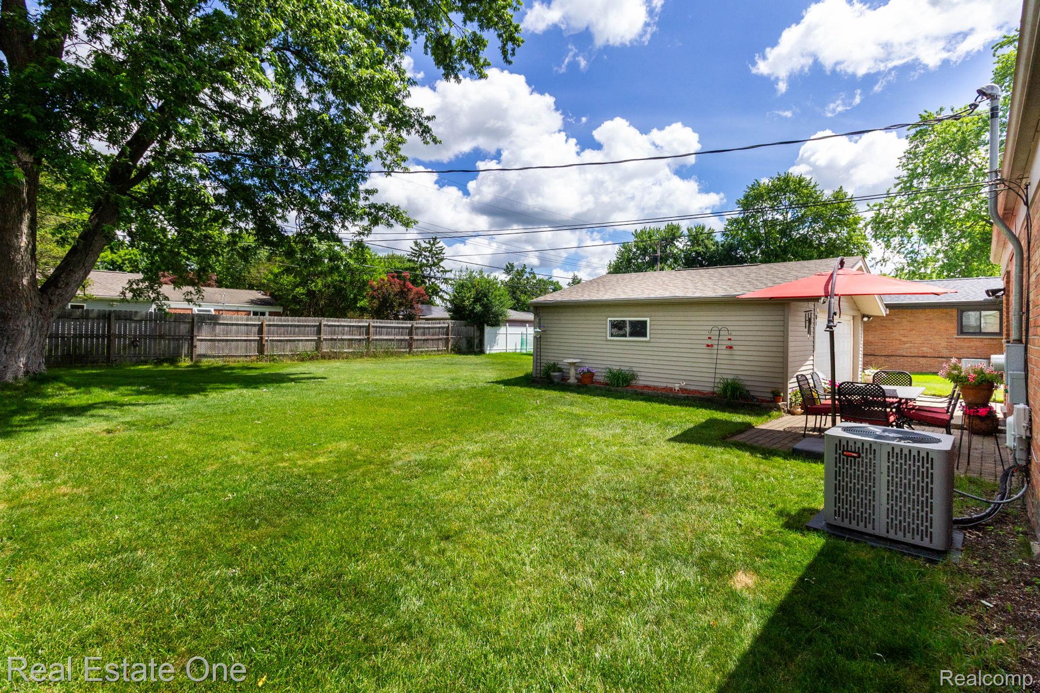 220 Winry Drive Rochester, MI 48307 - Photo 27 of 35 Expansive green lawn with mature perimeter trees and wood fencing
