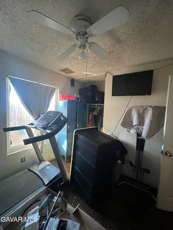 a living room with furniture a flat screen tv and a table