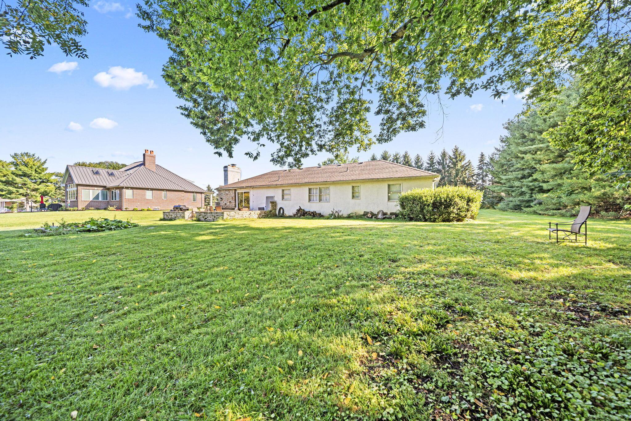 6344 Post Road Dublin, OH 43017 - Photo 32 of 45 Expansive green lawn with established trees and surrounding mature landscaping