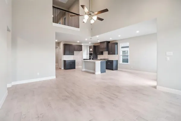 a view of a kitchen with a sink and a chandelier fan