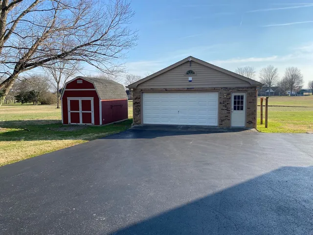 a front view of house with yard and garage