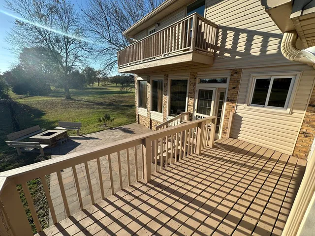 a view of a house with backyard and deck