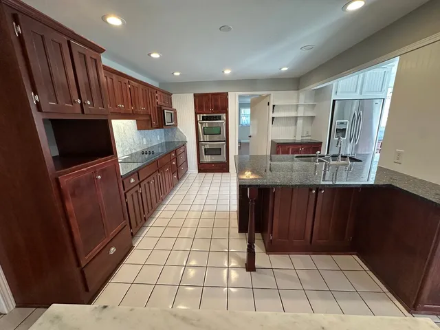 a large kitchen with a sink and cabinets