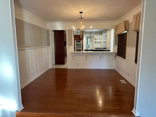 a view of a refrigerator in kitchen and wooden floor