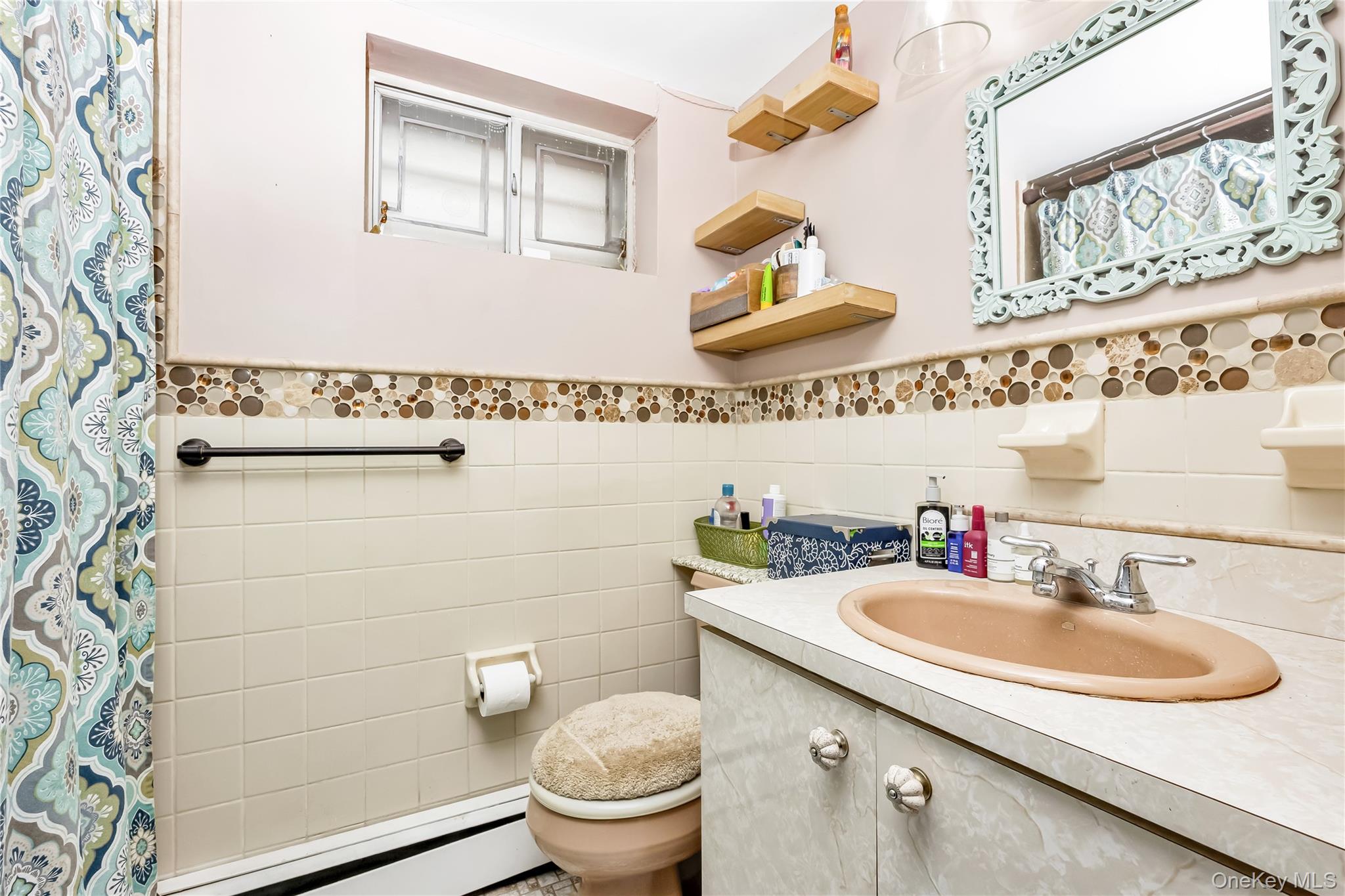 65-32 170th Street Queens, NY 11365 - Photo 14 of 24 a bathroom with a sink and a toilet