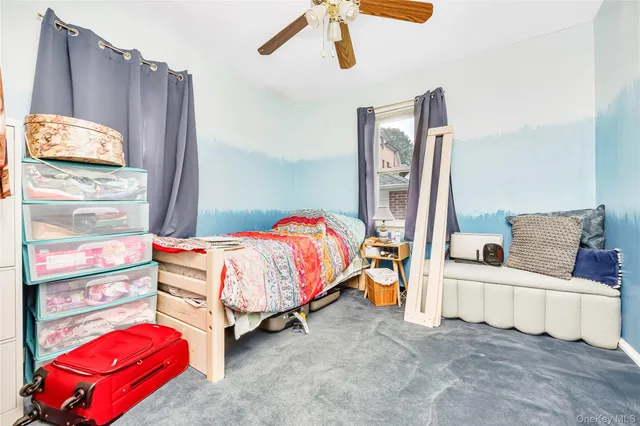 a bedroom with a bed and dresser