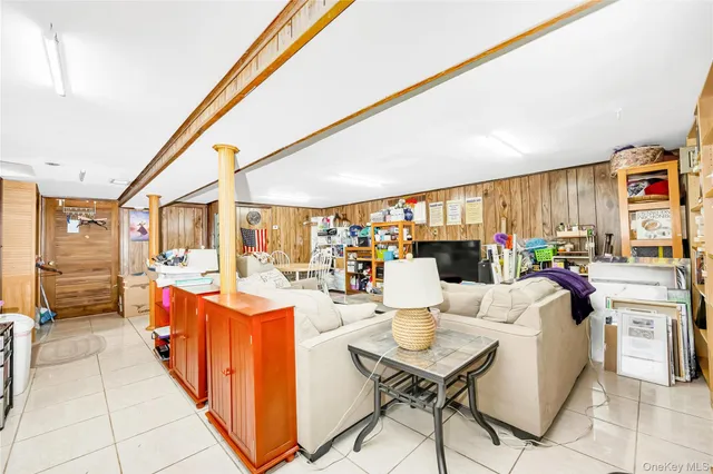 a dining room with furniture and a floor to ceiling window