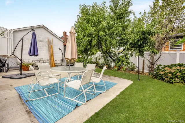 a view of a backyard with sitting area