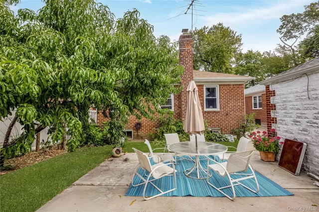 a view of backyard with outdoor seating a patio and plants