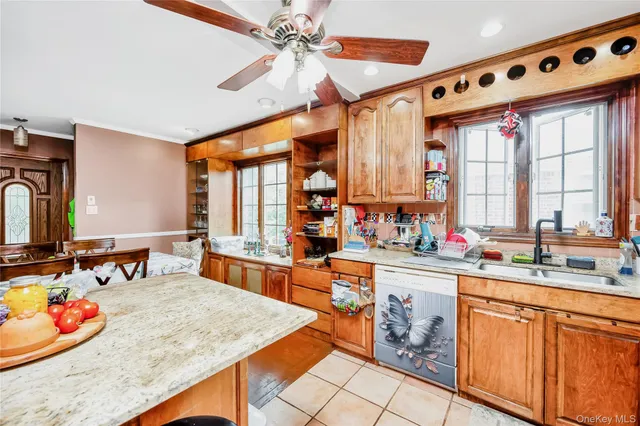 a kitchen with stainless steel appliances kitchen island granite countertop a sink and cabinets