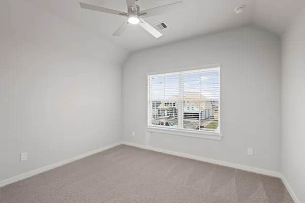 an empty room with closet and fan