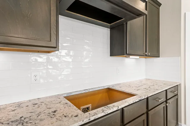 a view of kitchen cabinets and wooden floor