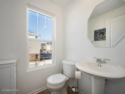 a white toilet sitting next to a bathroom sink