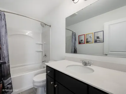 a bathroom with a sink toilet tub and shower
