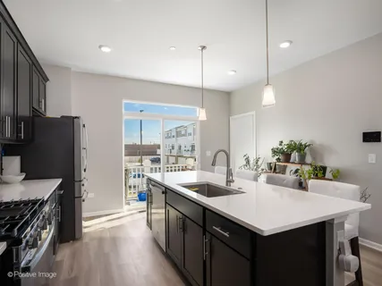 a kitchen with kitchen island a sink stove and wooden floor