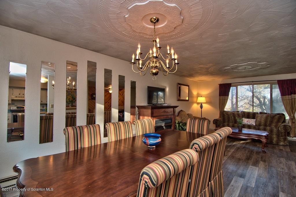 560 Maple Grove Road Moscow, PA 18444 - Photo 8 of 32 a view of a livingroom with furniture window and wooden floor
