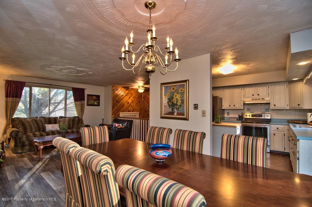 560 Maple Grove Road Moscow, PA 18444 - Photo 9 of 32 a living room with furniture dining table and a chandelier